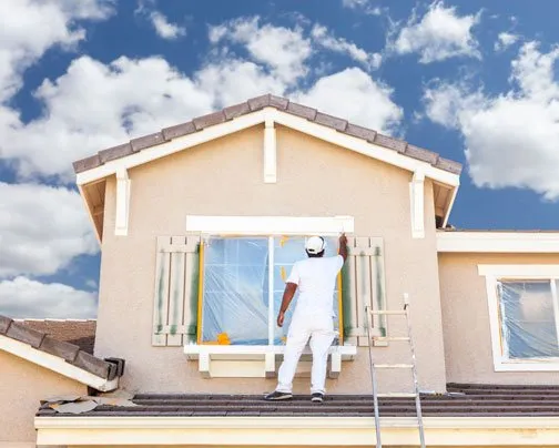 Man painting house exterior in Fort Lauderdale, FL