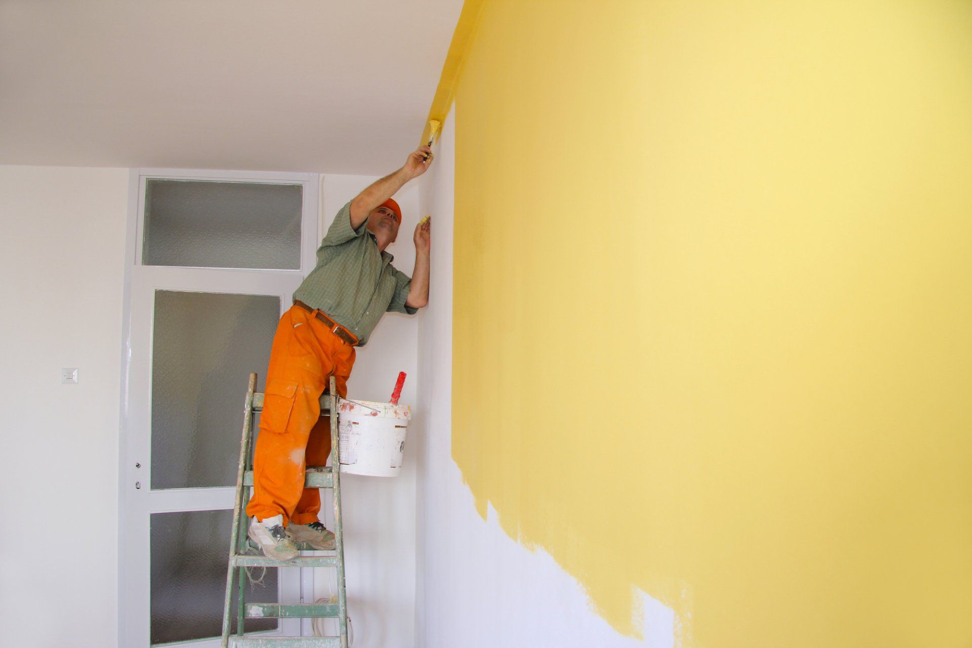 this wall in a Hollywood FL building is painted yellow by a Fort Lauderdale Painters contractor