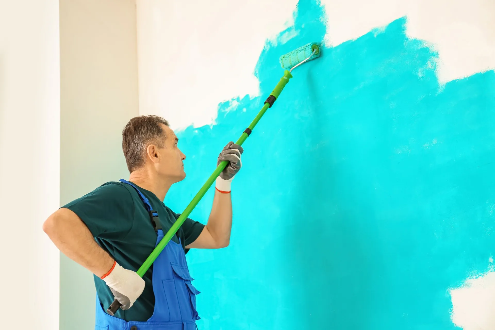 Commercial Painting Contractor painting the interior wall of a motel in Fort Lauderdale blue