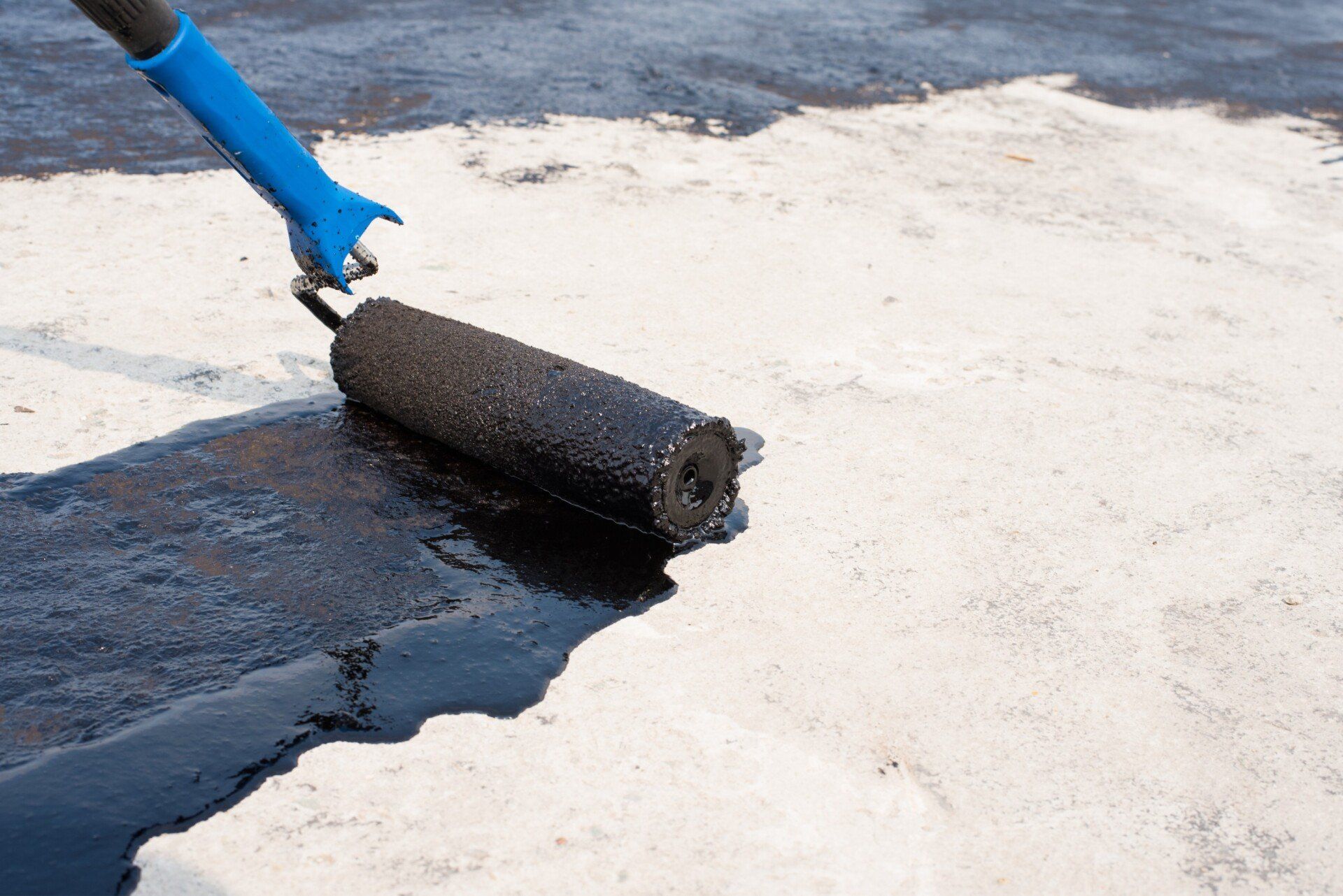 the waterproofing medium is applied using a roller brush